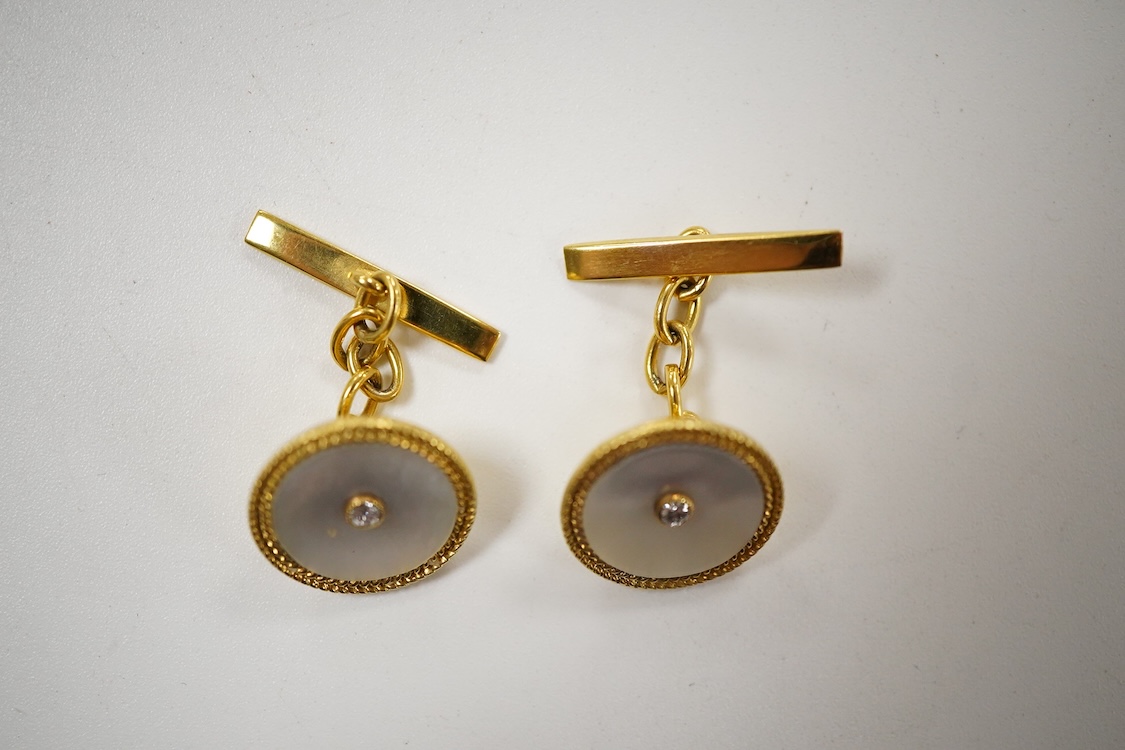 A pair of yellow metal (stamped 18) mounted, mother of pearl and diamond set disc cufflinks, diameter 12mm, gross weight 5.2 grams.